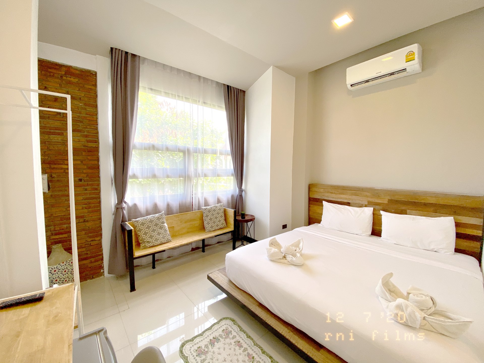 Deluxe Private King Suite spacious bed and timber accents